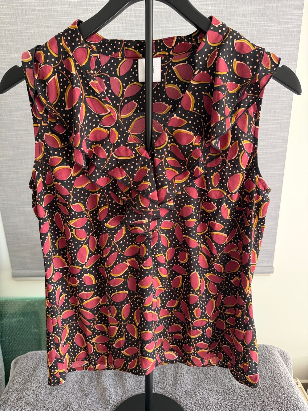 CAbi Sleeveless V-Neck Ruffle Top in Black with Pink and Mustard Leaf Print